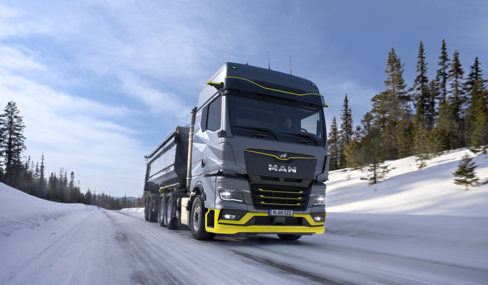 MAN commercial truck travelling on a snow-covered road